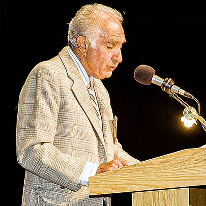 Image of Demenick Miretti standing at a podium